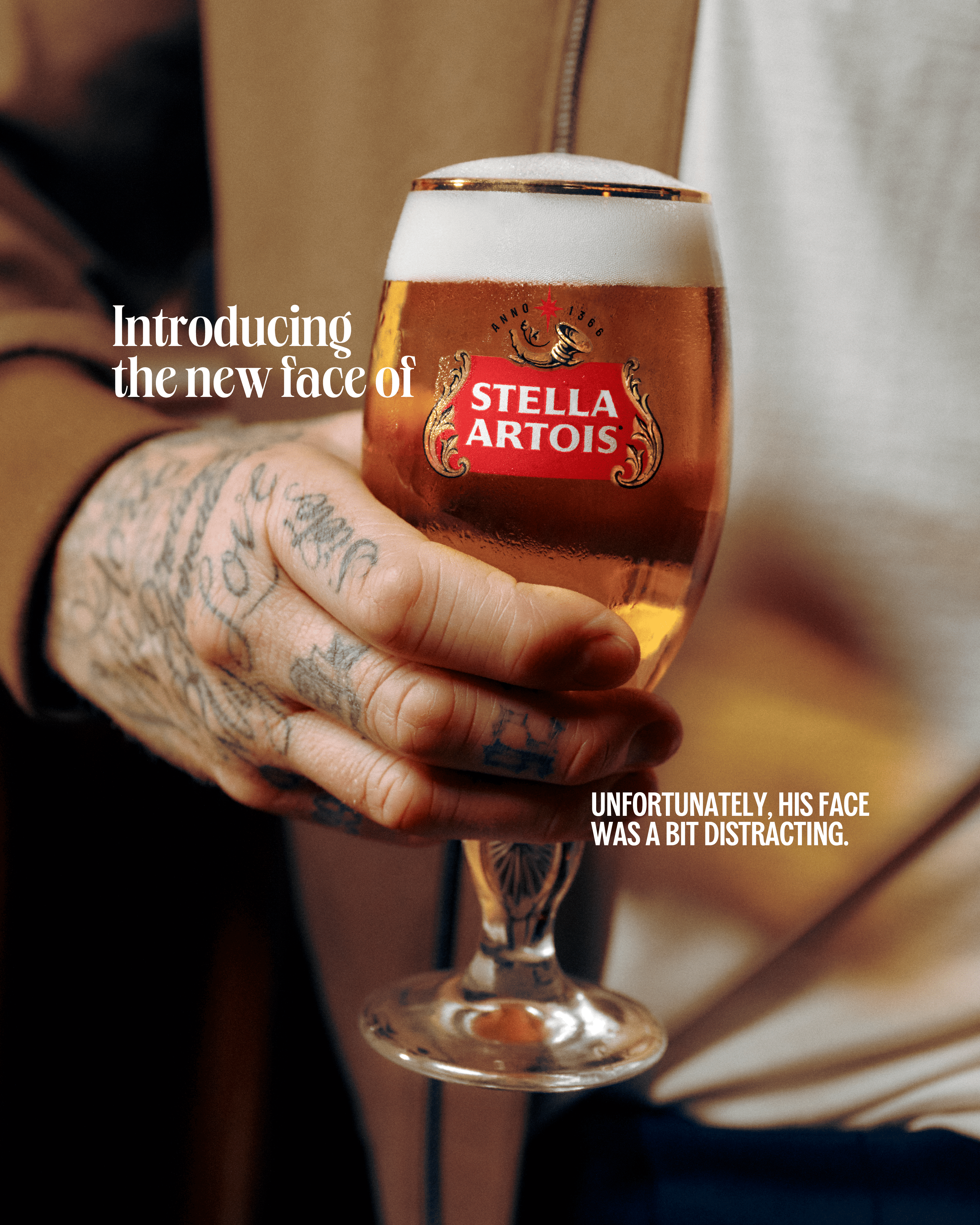 stella artois david beckham ad. david's tatood hand holds a glass of stella artois beer.